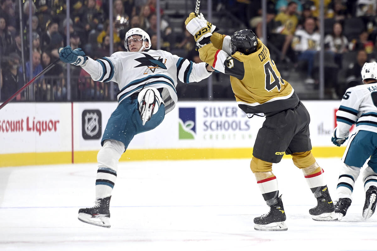 San Jose Sharks center Nico Sturm, left, is checked by Vegas Golden Knights center Paul Cotter ...