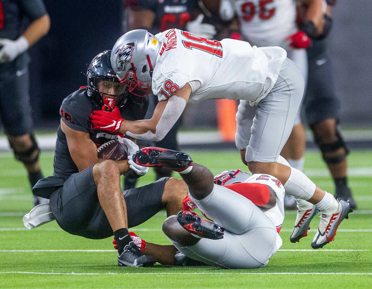 UNLV Rebels tight end Shaun Grayson (18) is taken down after a reception by New Mexico Lobos li ...