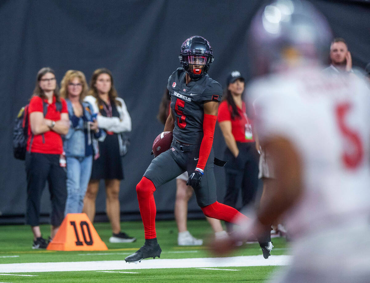 UNLV Rebels defensive back Cameron Oliver (5) heads to the end zone for a late score after an i ...