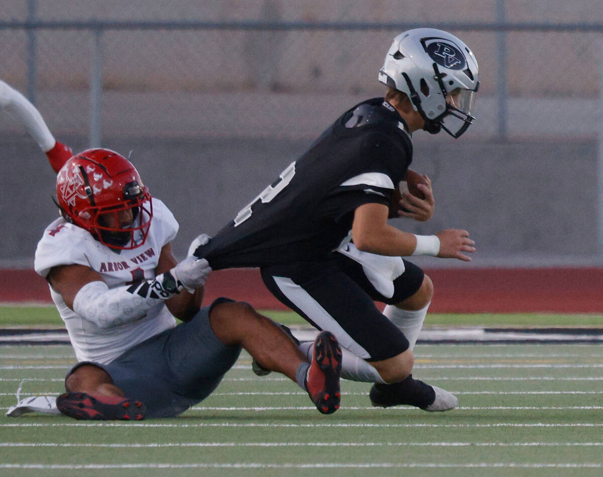 Arbor View’s Talavoutuputoa Howard, behind, sacks Palo Verde’s quarterback Crew D ...