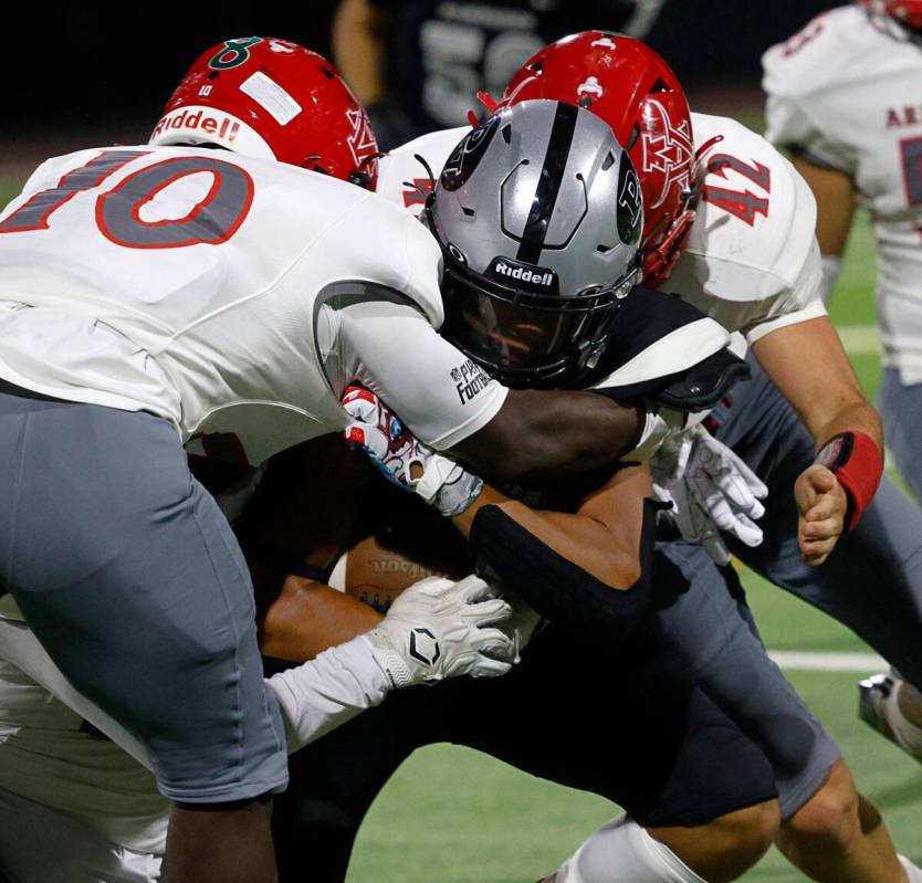 Arbor View’s Laron Atkins (10) and and Christian Thatcher (42) try to stop Palo Verde’s C ...