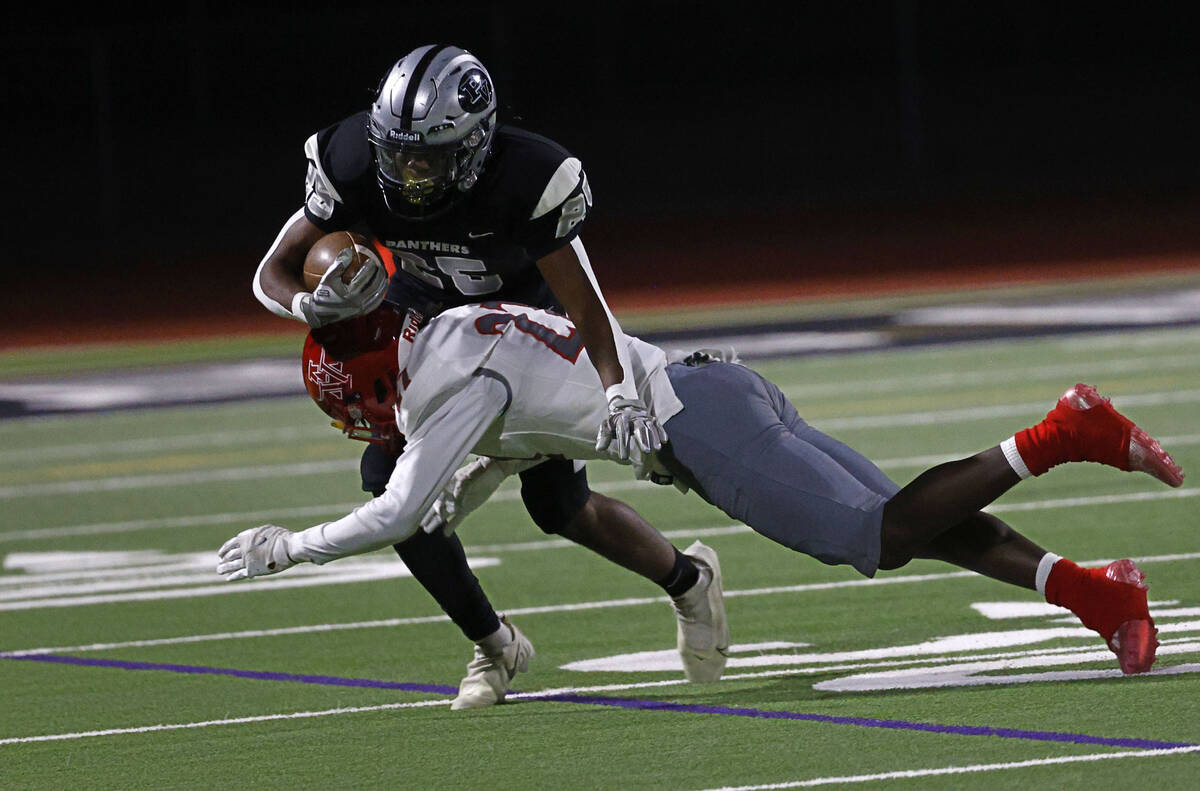 Palo Verde’s Bryant Johnson, top, carries the ball as Arbor View’s Bryce Heckard, ...