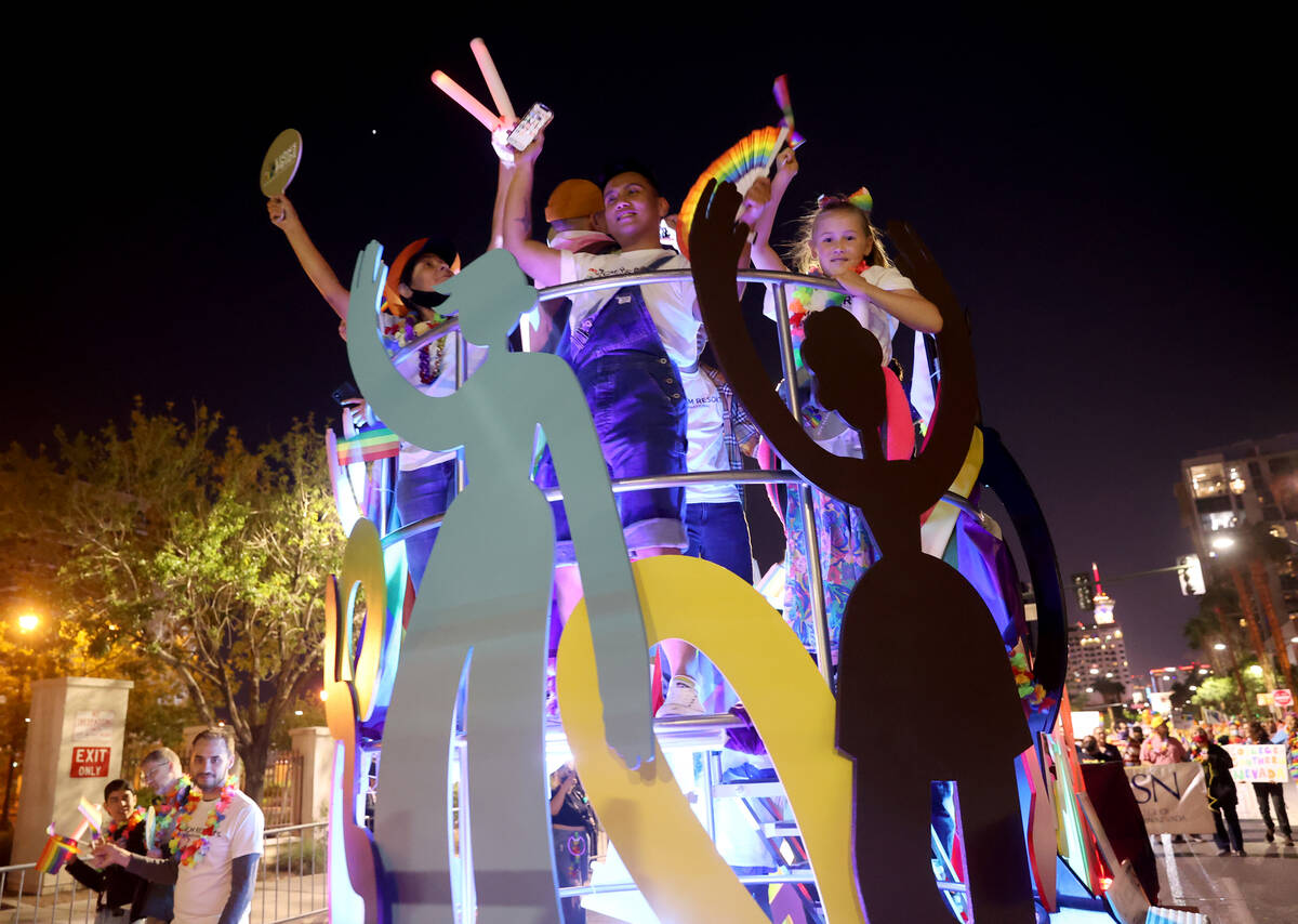 Members of MGM Resorts International entry march in the Las Vegas Pride Night parade downtown F ...