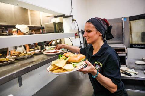 Server Brittney Crocker grabs food to expedite at The Omelet House at its central Las Vegas loc ...