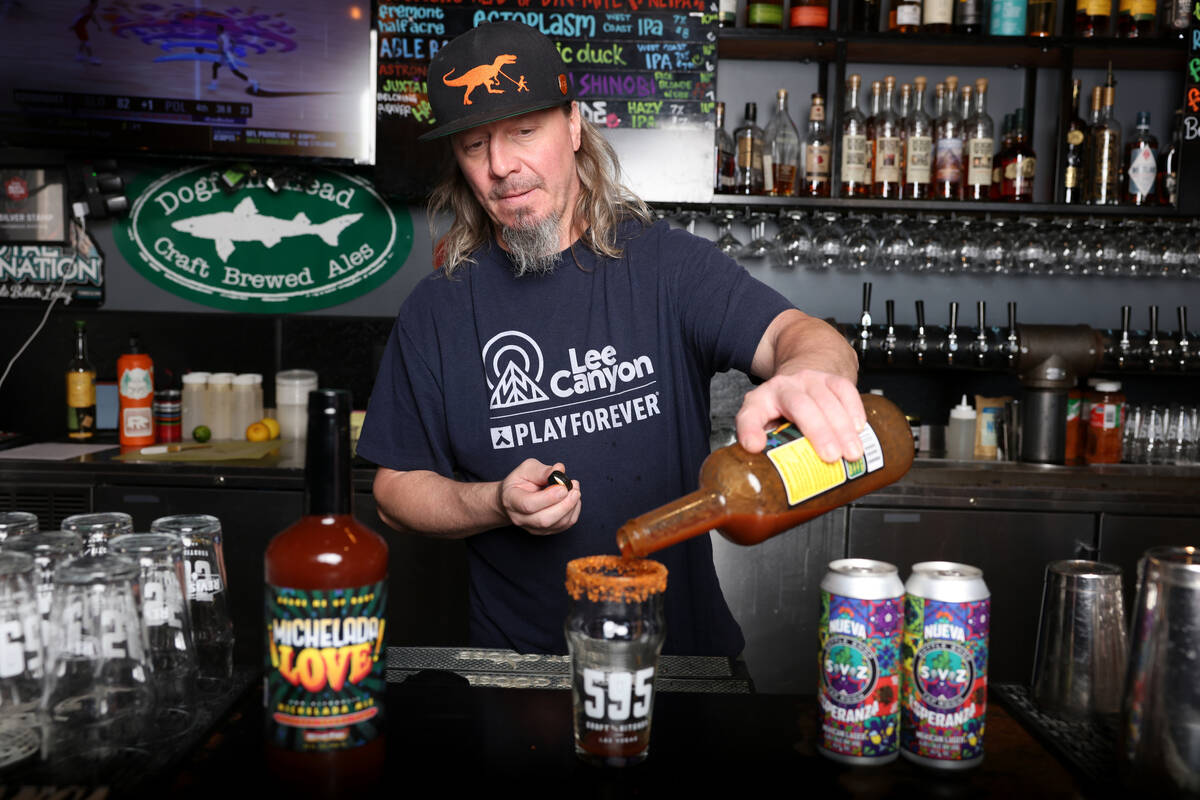 Bartender and certified cicerone Matt Alexander pours a michelada cocktail made with Michelada ...