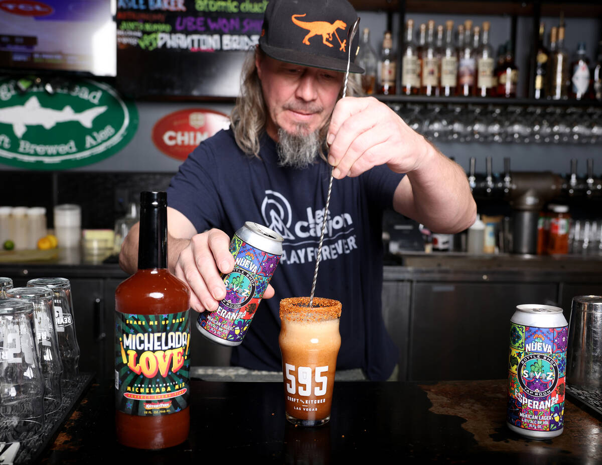Bartender and certified cicerone Matt Alexander pours a michelada cocktail made with Michelada ...