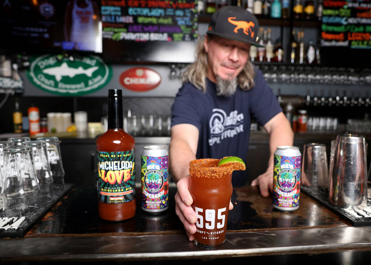 Bartender and certified cicerone Matt Alexander serves a michelada cocktail made with Michelada ...