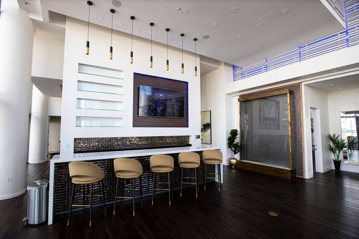 A bar in the living room area Is seen at the Palms Place penthouse locator on the entire top fl ...