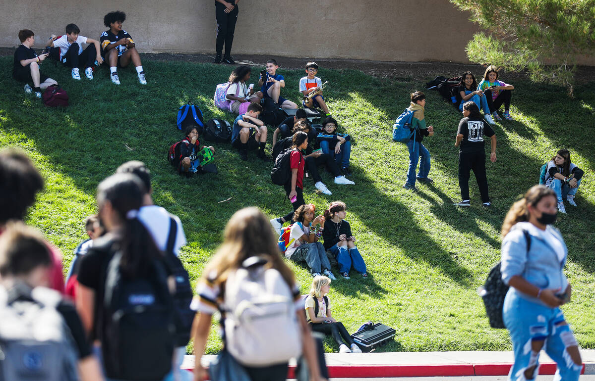 Students wait to be picked up and walk home outside Greenspun Junior High School in Henderson i ...
