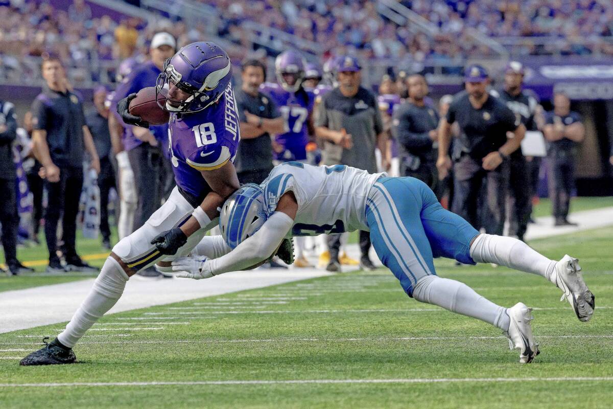 FILE - Minnesota Vikings wide receiver Justin Jefferson (18) carries the ball against Detroit L ...