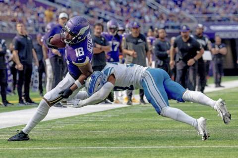 FILE - Minnesota Vikings wide receiver Justin Jefferson (18) carries the ball against Detroit L ...