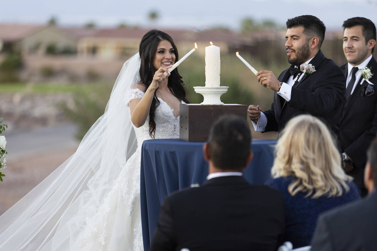 Brittany Castrejon, left, with her fiancé, Jorge Gonzalez-Calvillo, light up an unity cand ...
