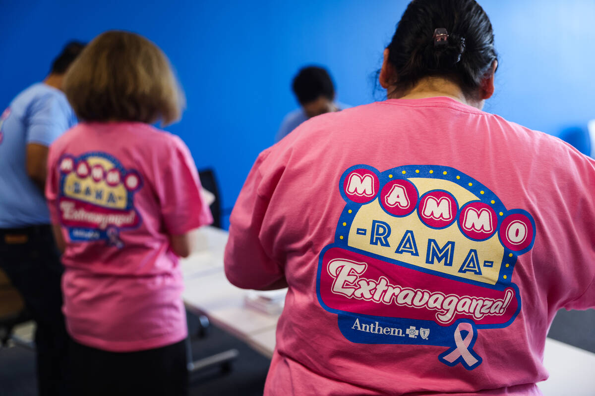 Paola Luzi, assistant for Anthem Nevada Medicaid, wears a shirt for the Mammo-Rama Extravaganza ...