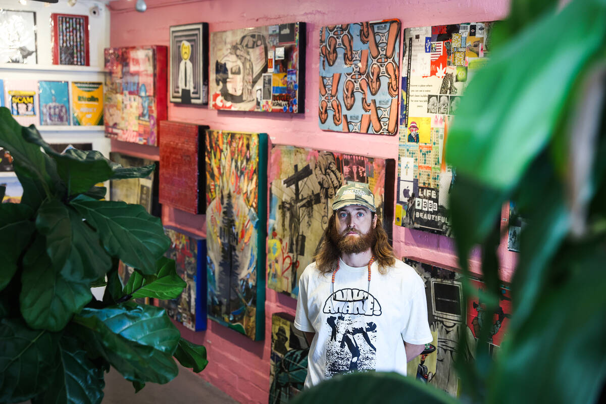 Izaac Zevalking, owner and artist at Recycled Propaganda, stands in front of his work at his st ...