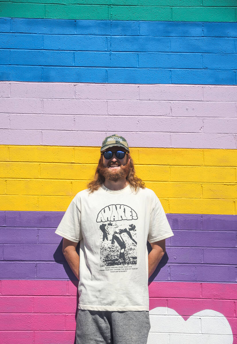 Izaac Zevalking, owner and artist at Recycled Propaganda, stands in front of an Arts District m ...