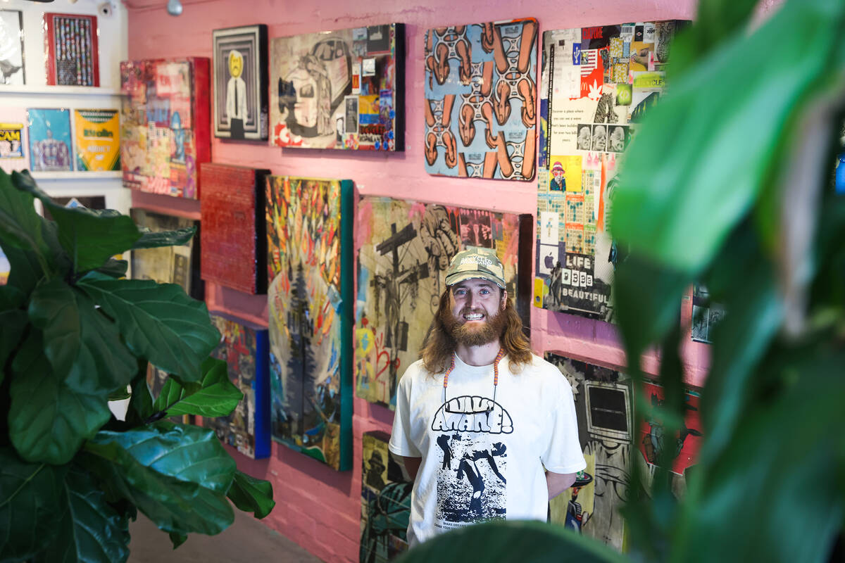 Izaac Zevalking, owner and artist at Recycled Propaganda, stands in front of his work at his st ...