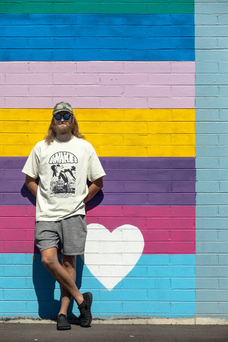 Izaac Zevalking, owner and artist at Recycled Propaganda, stands in front of an Arts District m ...