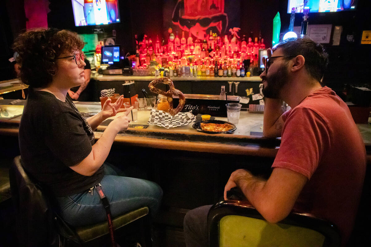 Eleanor Murphy, left, and Miguel Rivera, right, chat over food and drinks at the Millenium Fand ...