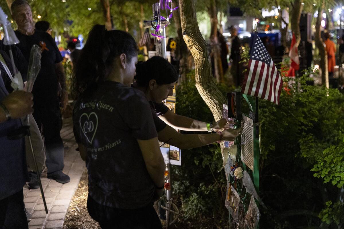 People attend a October 1 Remembrance Ceremony at the Las Vegas Community Healing Garden in Las ...