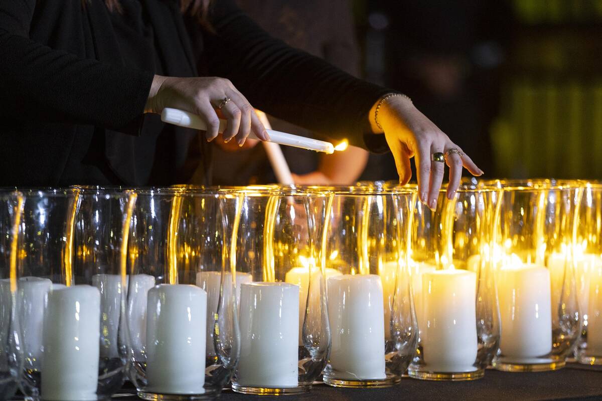 City of Las Vegas employee Maria Bigas lights up a candle for each of the victims from 1 Octobe ...