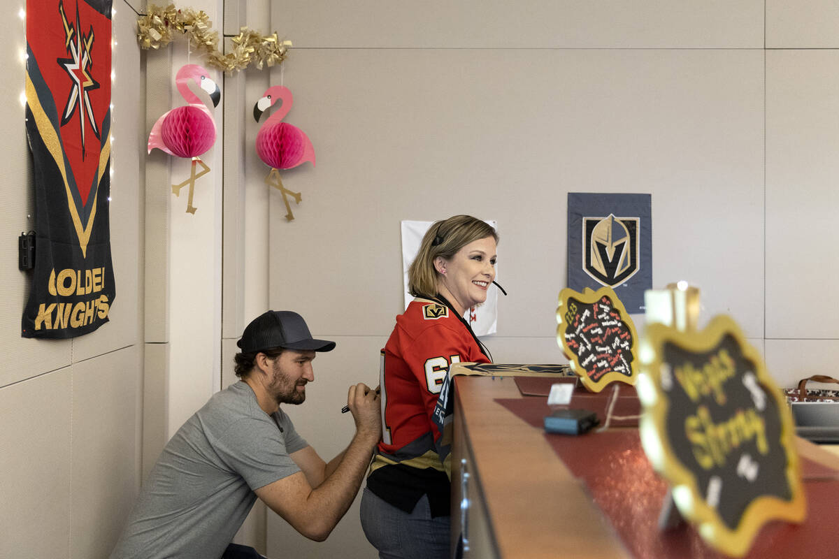 Golden Knights right wing Mark Stone signs the jersey of Kacy Rafferty, a 911 dispatcher, at he ...