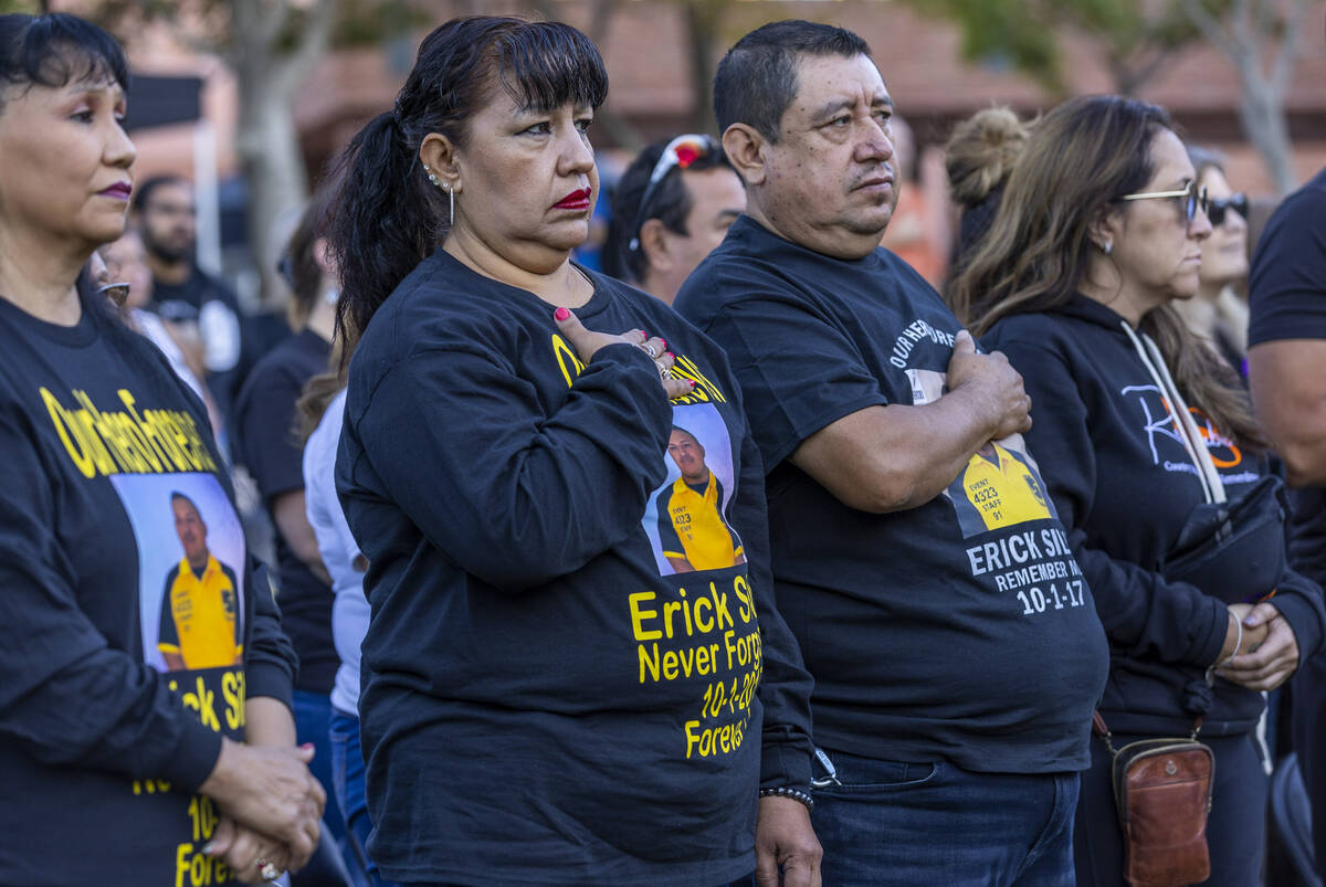 Family and friends of Erick Silva stand for the National Anthem during the Sunrise Remembrance ...