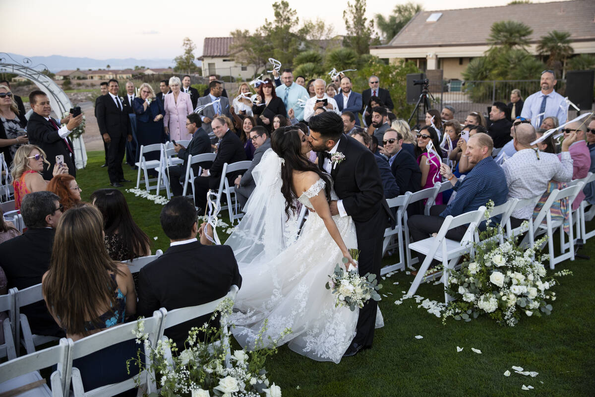 Brittany Castrejon, left, and her husband Jorge Gonzalez-Calvillo, share a kiss following their ...