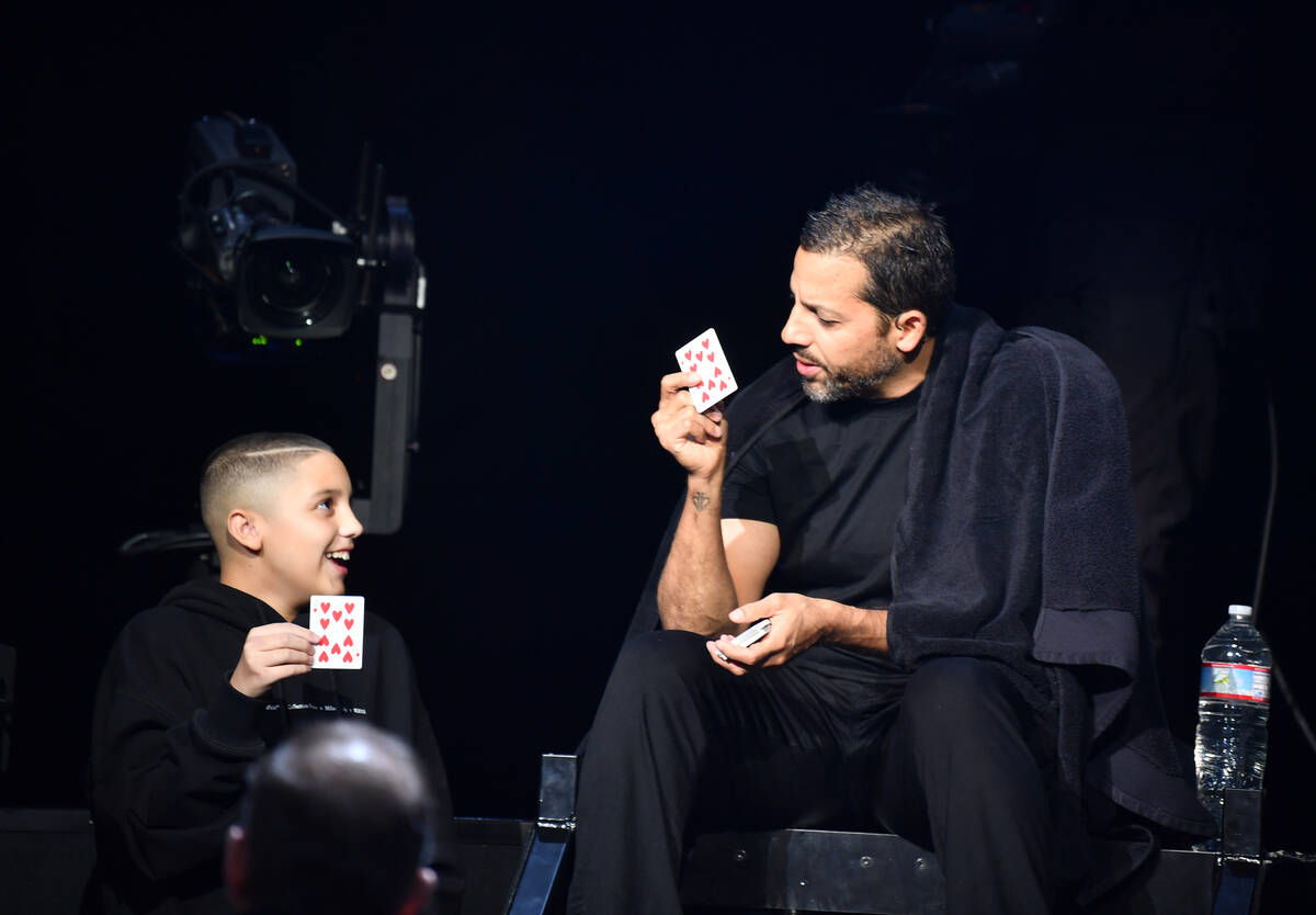 David Blaine and a young audience member are shown on opening night of "In Spades" show at The ...