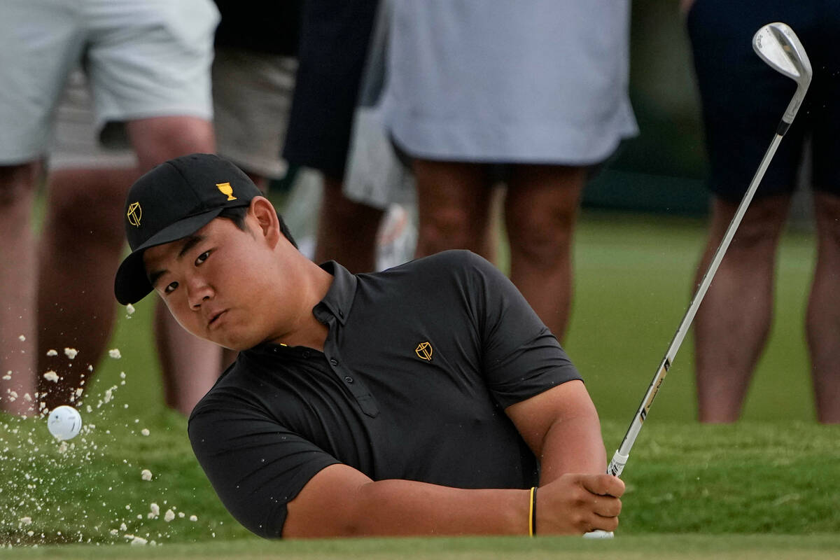 Tom Kim, of South Korea, hits from a bunker to the third green during their singles match at th ...