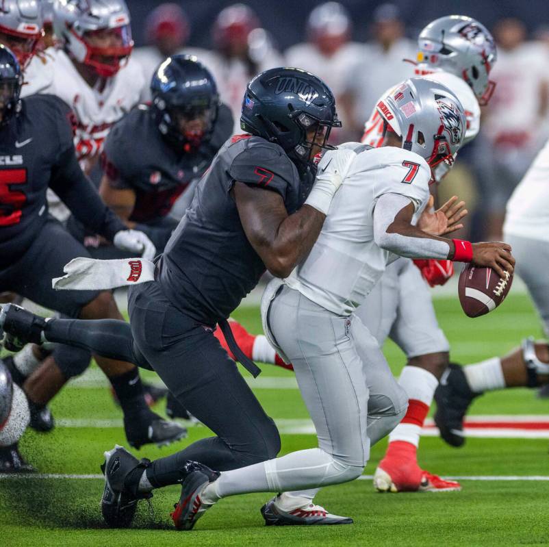 UNLV Rebels defensive lineman Adam Plant Jr. (7) sacks New Mexico Lobos quarterback CJ Montes ...
