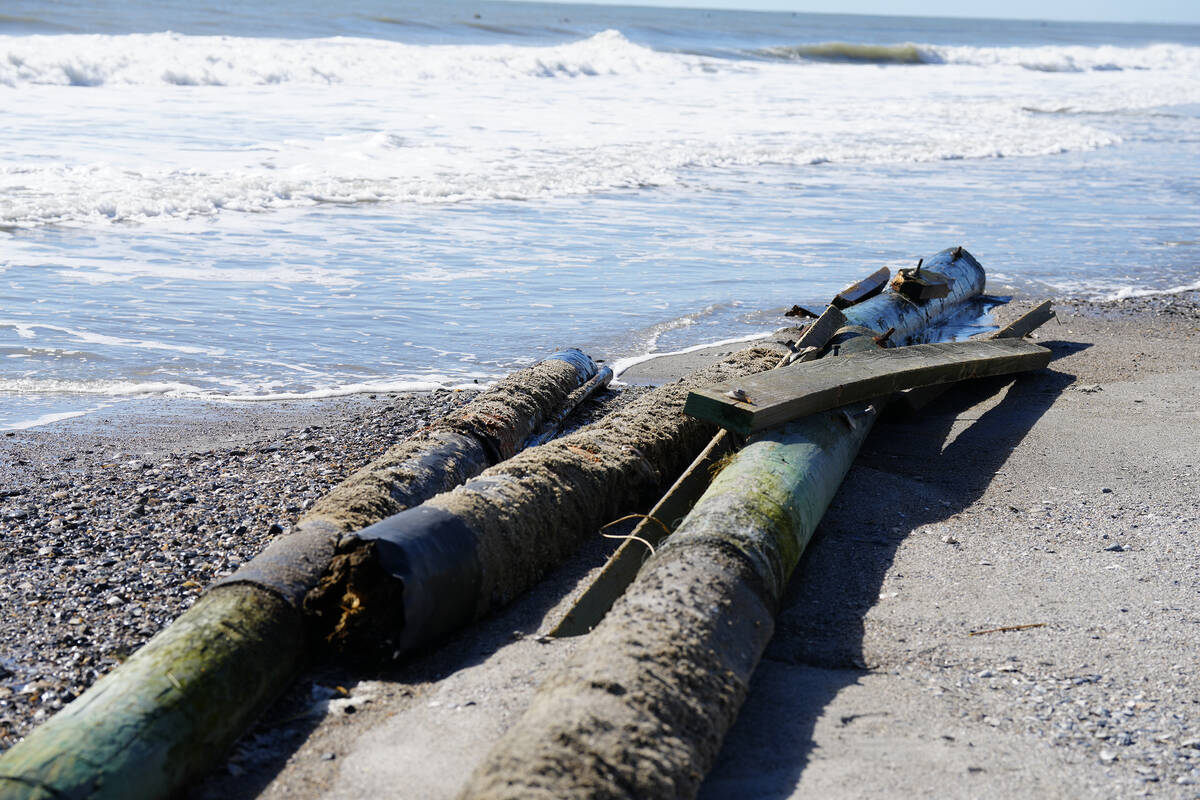 Pylons from the storied Pawleys Island Pier lie on the shore on Saturday, Oct. 1, 2022, in Pawl ...