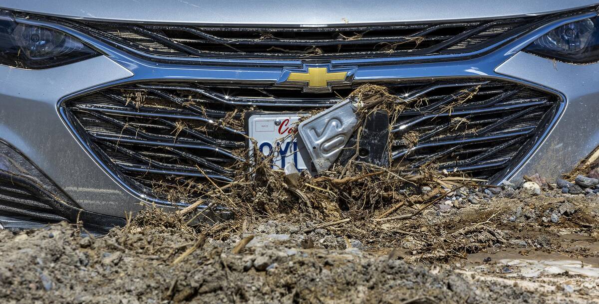 Cars remain stuck in mud flows in the parking lot of The Inn at Death Valley at the national pa ...