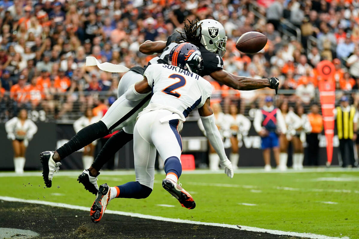 Denver Broncos cornerback Pat Surtain II (2) breaks up a pass intended for Las Vegas Raiders wi ...