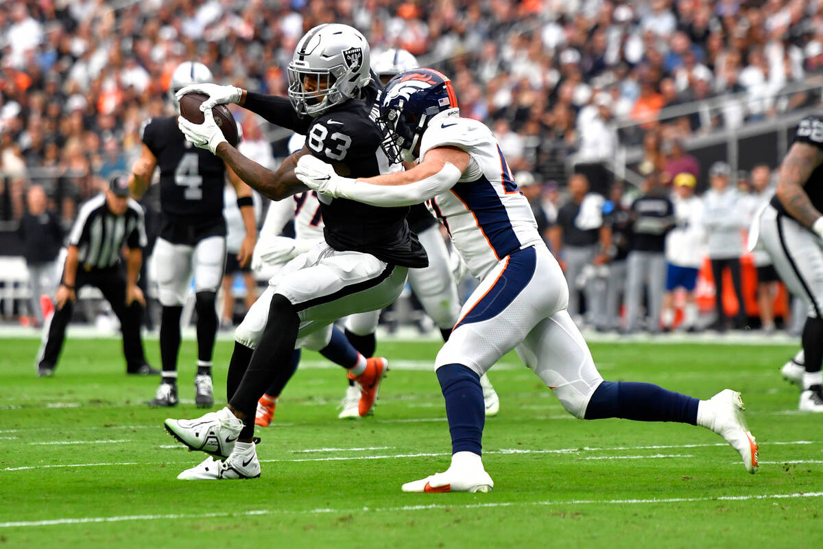 Las Vegas Raiders tight end Darren Waller (83) pulls in a catch as Denver Broncos linebacker Jo ...