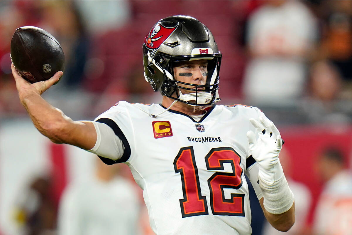 Tampa Bay Buccaneers quarterback Tom Brady warms up before an NFL football game against the Kan ...