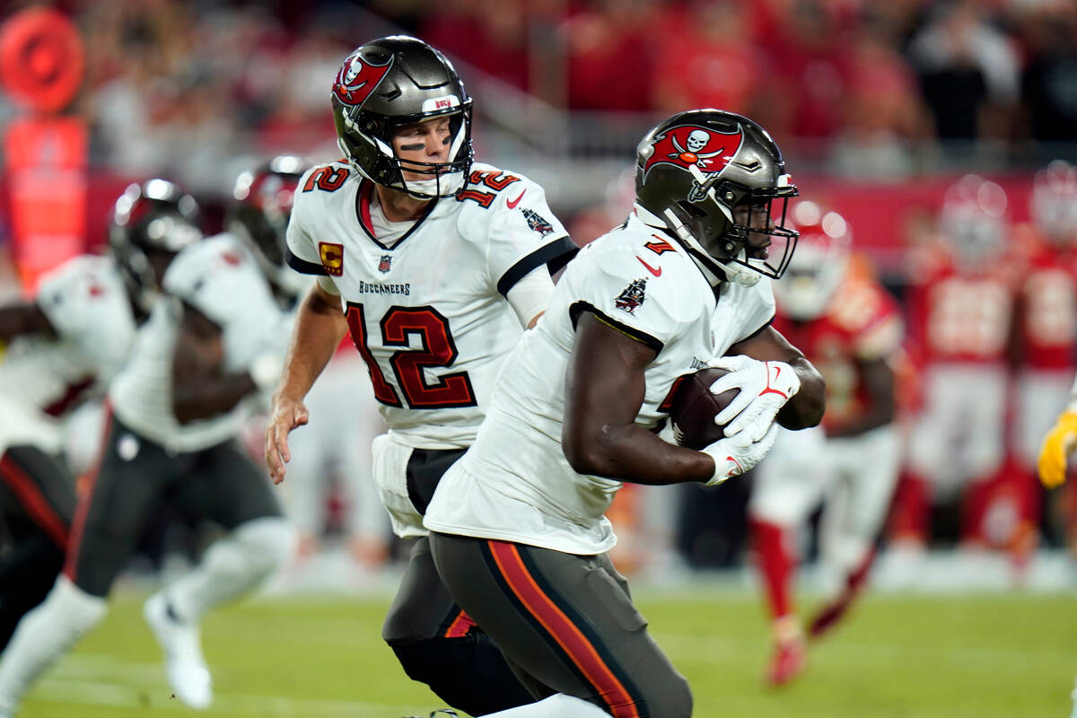 Tampa Bay Buccaneers quarterback Tom Brady (12) hands off the ball to running back Leonard Four ...