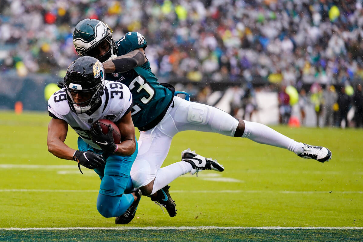 Jacksonville Jaguars' Jamal Agnew scores a touchdown in front of Philadelphia Eagles' C.J. Gard ...