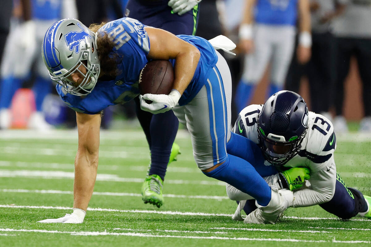 Detroit Lions tight end T.J. Hockenson (88) is tackled by s13 in the first half during an NFL f ...