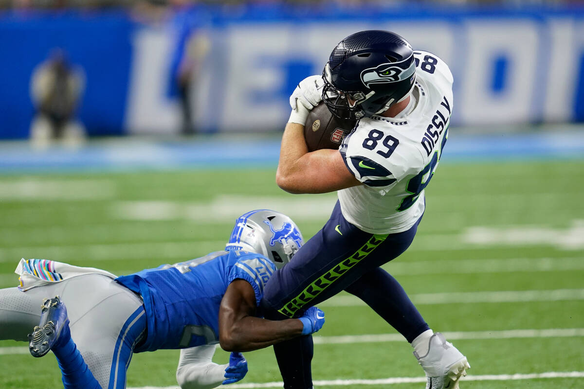 Seattle Seahawks tight end Will Dissly is tackled by Detroit Lions cornerback Amani Oruwariye d ...