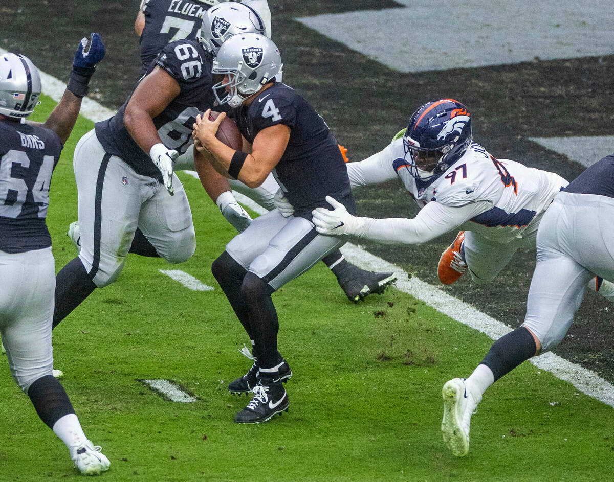 Raiders quarterback Derek Carr (4) is sacked near the end zone by Denver Broncos defensive tack ...