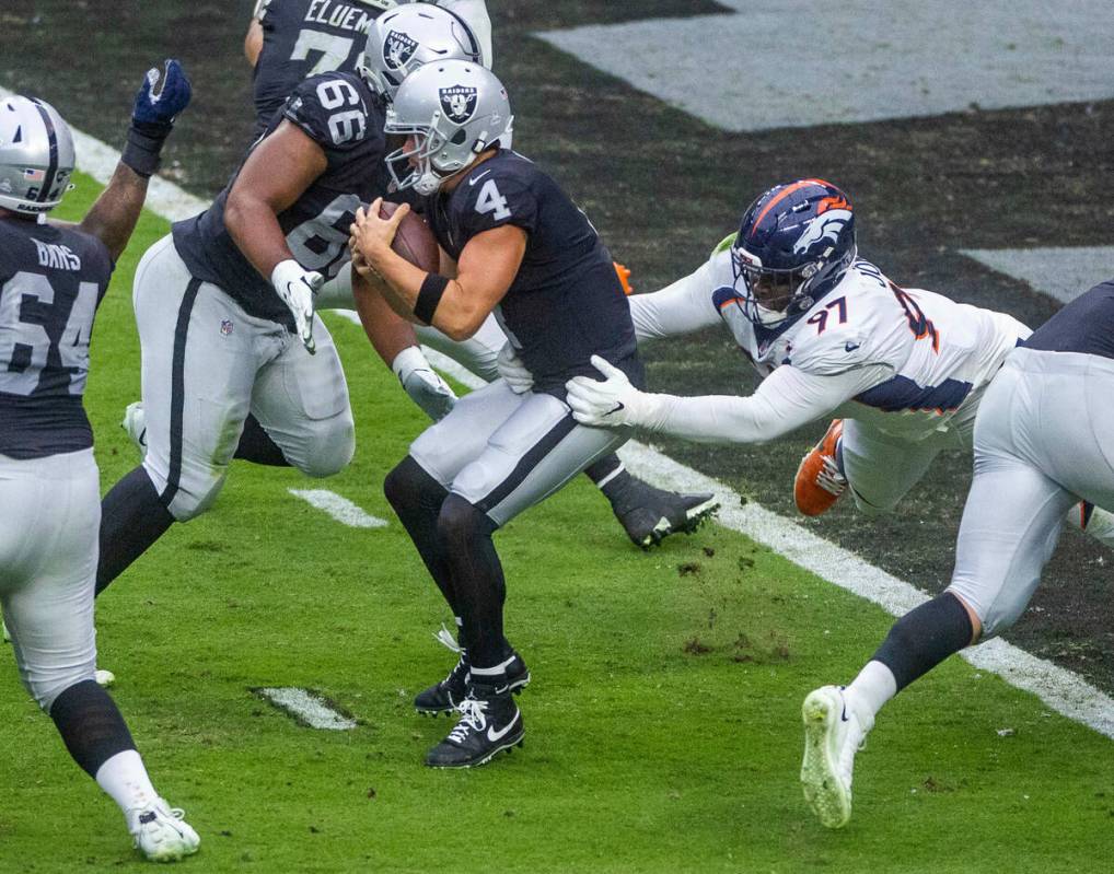 Raiders quarterback Derek Carr (4) is sacked near the end zone by Denver Broncos defensive tack ...