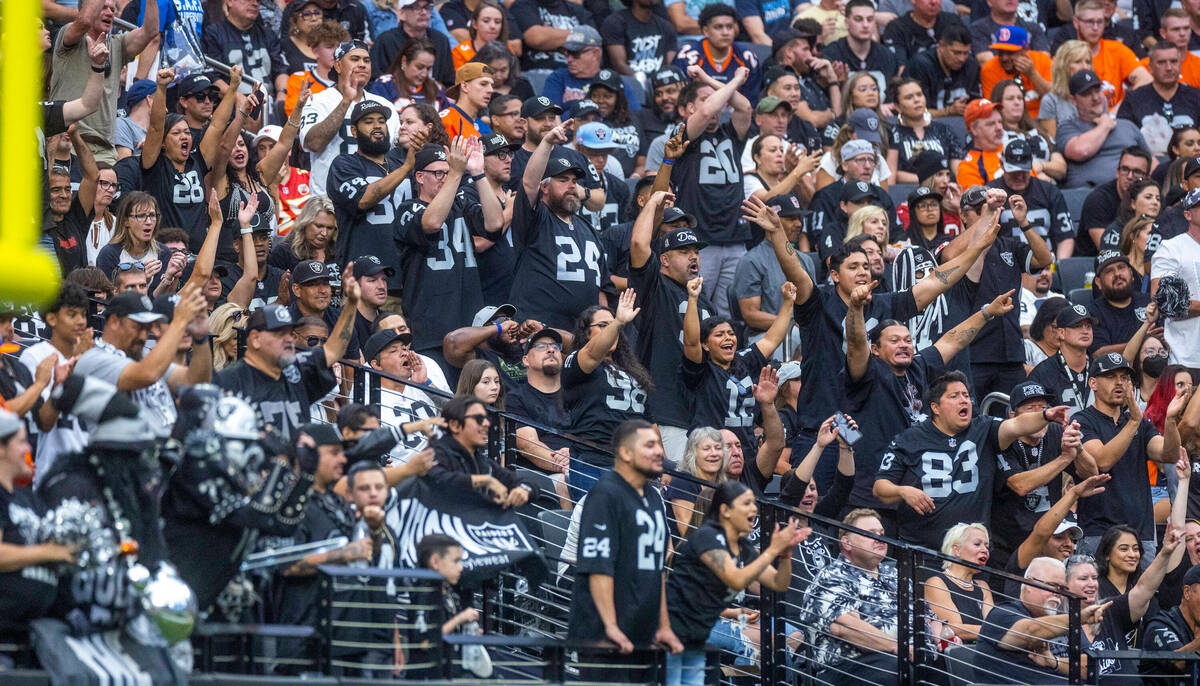 Raiders fans celebrate a score over the Denver Broncos during the first half of their NFL game ...