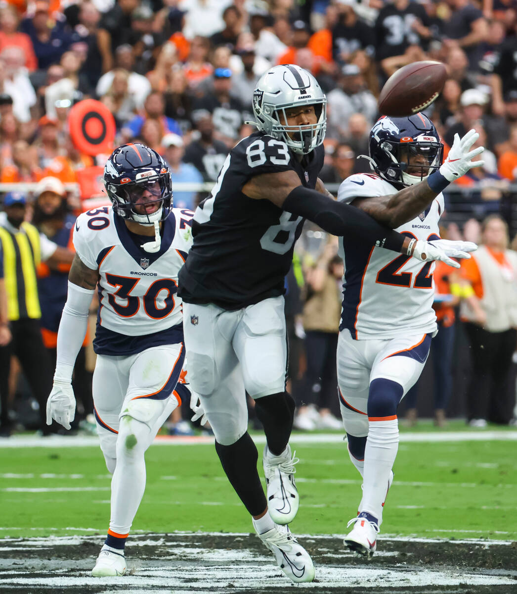 A pass intended for Raiders tight end Darren Waller (83) is broken up by Denver Broncos safety ...