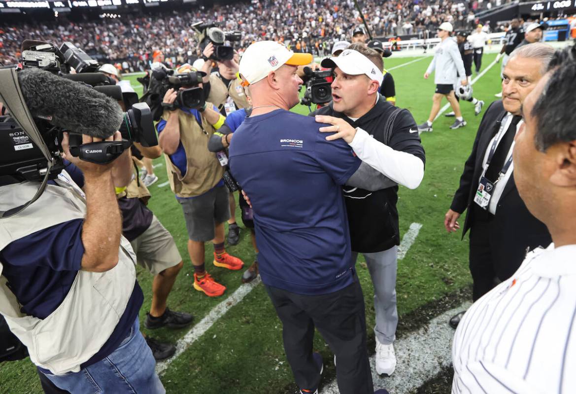 Raiders head coach Josh McDaniels greets Denver Broncos head coach Nathaniel Hackett after McDa ...
