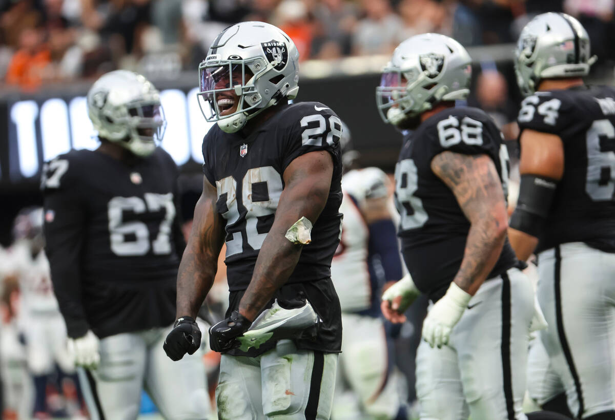 Raiders running back Josh Jacobs (28) reacts after his touchdown against the Denver Broncos dur ...