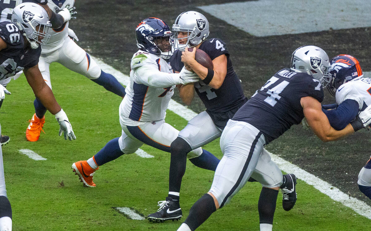 Raiders quarterback Derek Carr (4) is sacked near the end zone by Denver Broncos defensive tack ...