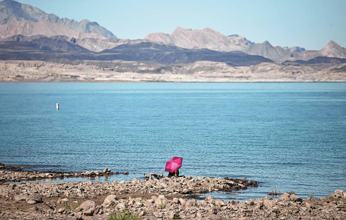 FILE - People hang out at Swim Beach, along the Boulder Basin and Boulder Beach area, at Lake M ...