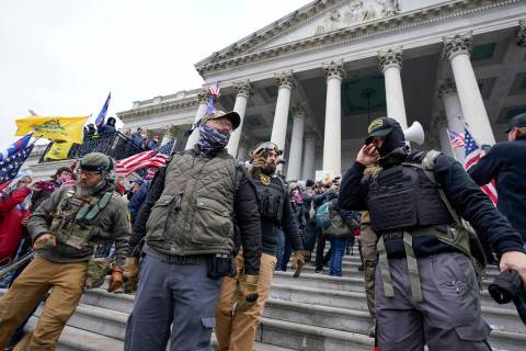FILE - Members of the Oath Keepers stand on the East Front of the U.S. Capitol on Jan. 6, 2021, ...