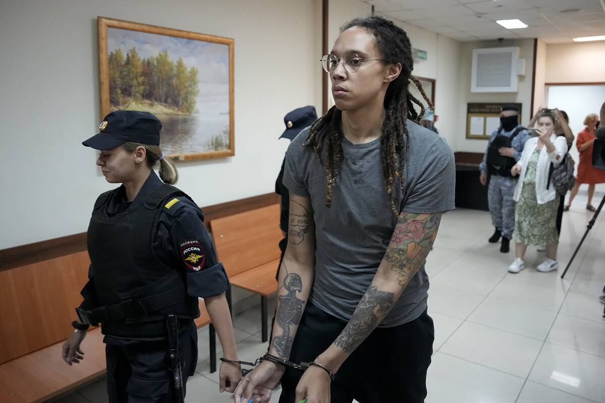 FILE - WNBA star and two-time Olympic gold medalist Brittney Griner is escorted from a court ro ...