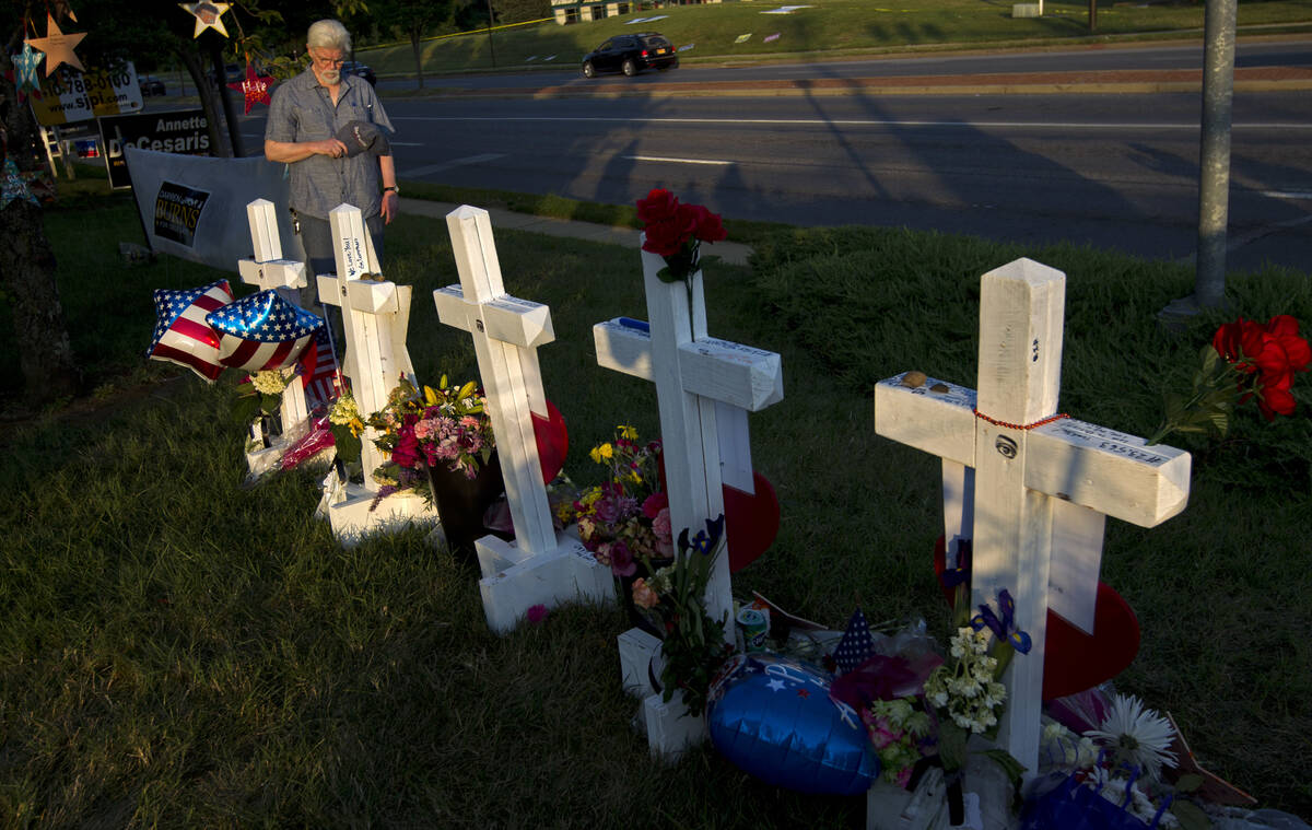Capital Gazette reporter E.B. Furgurson III pauses by the crosses representing his five colleag ...